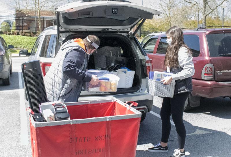 Student packing belongings in car